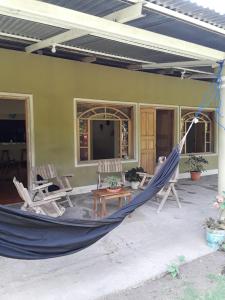 a hammock on the porch of a house at Sophie House in Moyogalpa