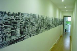 a mural of a city on a wall in a hallway at Residence Metro-Alameda in Lisbon