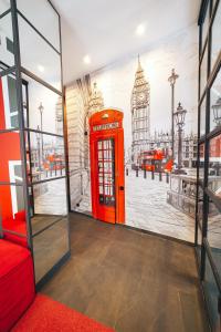 a red phone booth with a picture of big ben at Cities Gallery Apart-hotel in Lviv