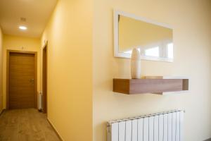 a mirror on the wall of a hallway at APARTAMENTOS COSTA XUÑO in Porto do Son