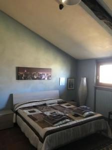 a bedroom with a large bed and a window at Cascina Garaita in Fossano