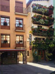 a building with flower boxes and balconies on it at Duplex a la plaça Major in El Pont de Suert