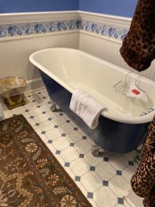 a bath tub in a bathroom with a tile floor at Nestle Inn in Indianapolis