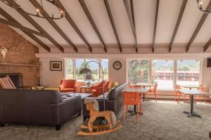 a living room with couches and chairs and a fireplace at Discovery Lodge in Estes Park