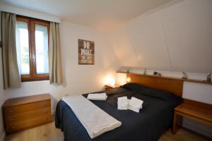 Un dormitorio con una cama con dos almohadas encima. en Chalé Acolhedor - Penhas da Saúde - Serra da Estrela, en Covilhã