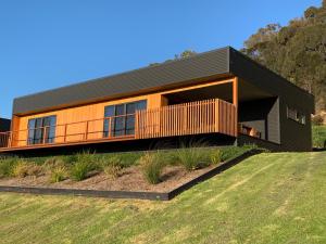 a modern house with a black roof at Villa 1 in Port Campbell