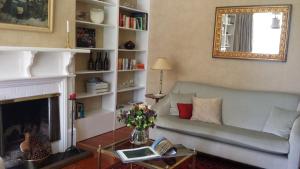 a living room with a couch and a fireplace at The Peppertree Luxury Accommodation in Blenheim