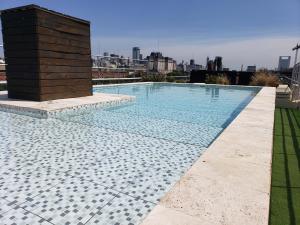 a swimming pool on the roof of a building at Puerto Madero con Amenities in Buenos Aires