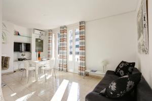 a living room with a couch and a table at Appartements Cannes in Cannes