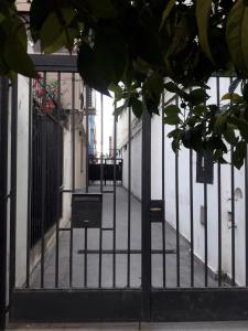 an open gate in a building with a courtyard at La Rojarilla in San Miguel de Tucumán