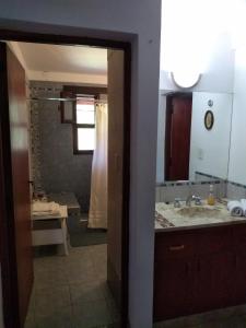 a bathroom with a sink and a shower at El Indalo La Calderilla in Salta