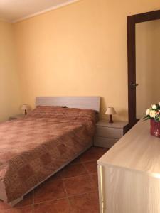 a bedroom with a bed and two tables with lamps at La villetta senza tempo in Aprilia +38 photos