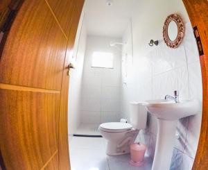 a bathroom with a toilet and a sink at Casa Toniatti 2 in Barra Grande