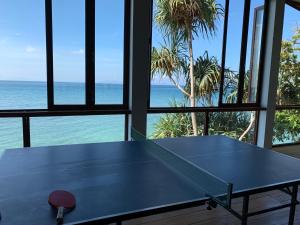 a ping pong table with a view of the ocean at Pulau Weh Paradise in Sabong