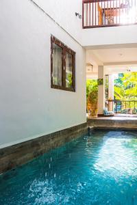 a swimming pool in the middle of a house at Talisay Boutique Hotel in El Nido