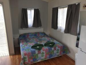 a bedroom with a bed with green bows on it at Big4 Acclaim Prospector Holiday Park in Kalgoorlie