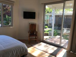 a bedroom with a bed and a sliding glass door at SIGNAL BOX Short Stay in Gembrook