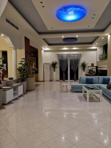 a lobby with couches and a blue ceiling at Louis Luxury Villa by filoxenia in blue in Rhodes Town