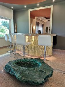 a bar in a room with a table and chairs at Louis Luxury Villa by filoxenia in blue in Rhodes Town