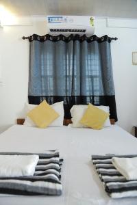 1 dormitorio con 1 cama grande y ventana en Baywatch Beach Resort, en Alleppey