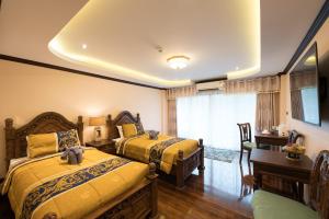 Giường trong phòng chung tại Thanyawintra Boutique and Spa