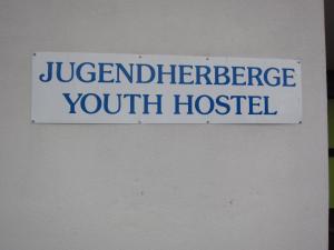 
a blue and white sign on a white wall at Junges Hotel Melk in Melk
