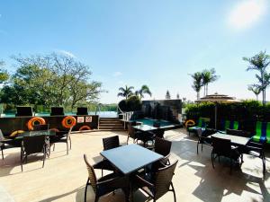 a patio with tables and chairs on a deck at Welcomhotel by ITC Hotels, Richmond Road, Bengaluru in Bangalore