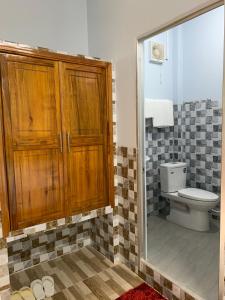 a bathroom with a toilet and a mirror at Thảo Trân in Ha Tien