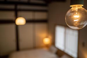 a close up of a light bulb hanging from a ceiling at ゑびすや in Kofu