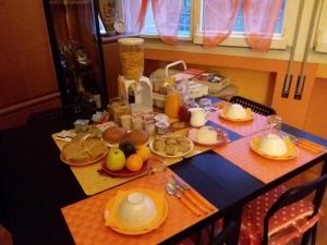 a table with food and fruit on top of it at Orange House in Varenna