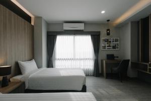 Postel nebo postele na pokoji v ubytování Arista Hotel Ubon