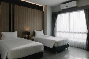 Postel nebo postele na pokoji v ubytování Arista Hotel Ubon