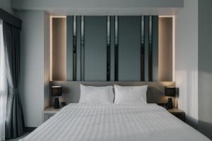 Postel nebo postele na pokoji v ubytování Arista Hotel Ubon