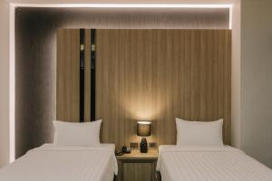 Postel nebo postele na pokoji v ubytování Arista Hotel Ubon