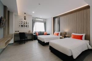 Postel nebo postele na pokoji v ubytování Arista Hotel Ubon