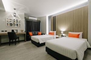Postel nebo postele na pokoji v ubytování Arista Hotel Ubon