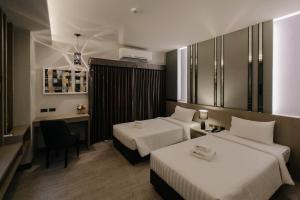 Postel nebo postele na pokoji v ubytování Arista Hotel Ubon