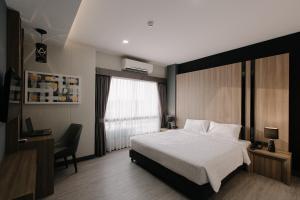 Postel nebo postele na pokoji v ubytování Arista Hotel Ubon