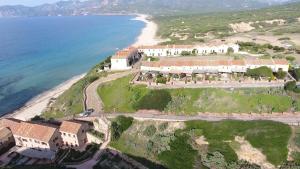 an aerial view of a house on a hill next to the ocean at B&B Del Viale in Bacu Abis