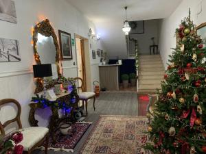 a living room with a christmas tree and a staircase at Albergo Lamanna in Taranto