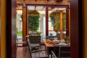 a restaurant with tables and chairs on a patio at UNAWAY Ecohotel Villa Costanza Venezia in Mestre