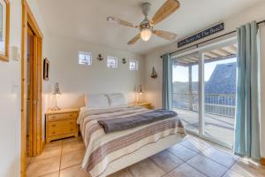 a bedroom with a bed and a large window at Grey Haven in Rockaway Beach