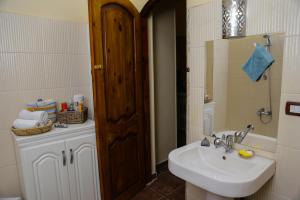 a bathroom with a sink and a mirror at Habibi Nubian Guest House-Nubian Hospitality in Aswan +166 photos