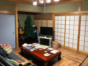 a living room with a couch and a table at Konpira House in Kotohira