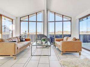 a living room with two couches and a table at 8 person holiday home in Hj rring in Hjørring