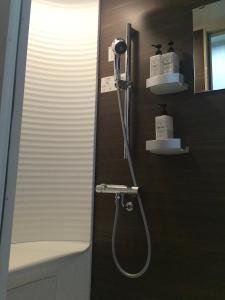 a bathroom with a shower and a sink at Konpira House in Kotohira