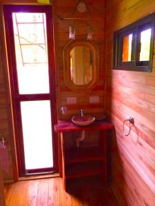 a bathroom with a sink and a mirror at Cabañas Tunkelen in Punta Indio