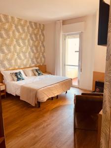 a bedroom with a bed and a large window at Hotel Montecarlo - Hotel Vista Mare con Piscina & Area Fitness in Riccione +88 photos