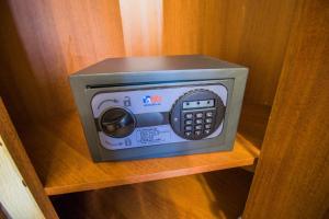 a small microwave oven sitting on a wooden shelf at Hotel Moskva in Gelendzhik