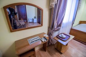 a room with a mirror and a table with a camera at Hotel Moskva in Gelendzhik